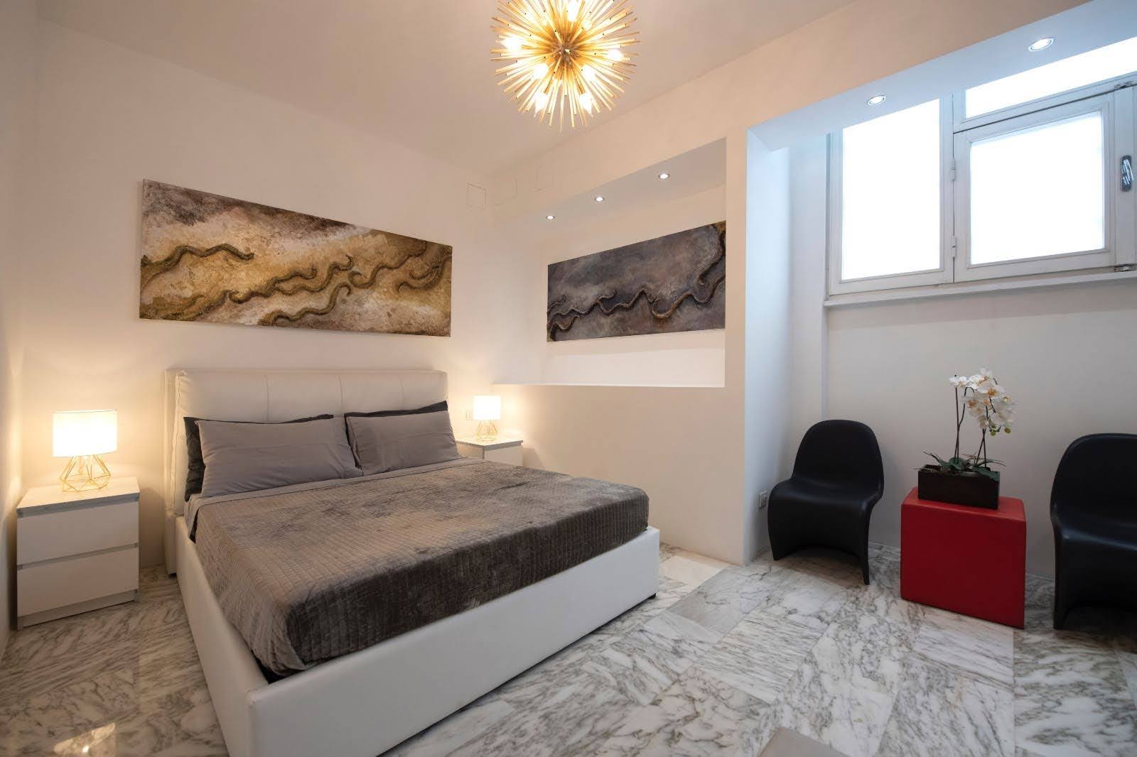 Quiet bedroom for a luxury stay in Milan with soft lighting and marble flooring